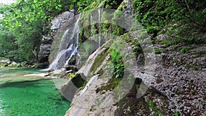 4K. Waterfall Virje in Slovenian Alps, clean blue water and green forest. Julian Alps, Bovec district, Slovenia, Europe