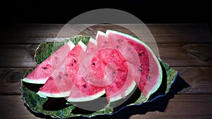 4k. Watermelon flesh close-up. the rotation of the watermelon on wood background