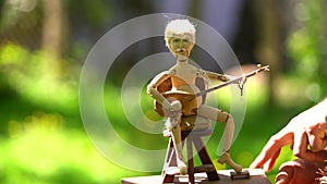 4K wooden mechanical toy man playing an instrument. A master manufactures wooden mechanical toys in Turkey.