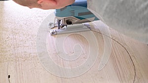 4k. Working fretsaw closeup. Carpenter sawing wood with the electric saw - fretsaw. Saw with an electric jigsaw thick