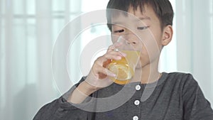 4k Young Asian boy drink soda orange juice bubble