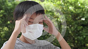 4k Young Asian boy wearing a face mask to protect virus