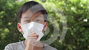 4k Young Asian boy wearing a face mask to protect virus