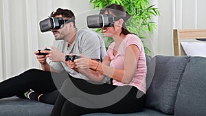 4K Young couple playing games with virtual reality glasses having fun together