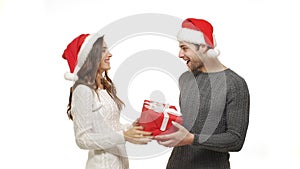 4k young girlfriend close her boyfriend eyes and surprise her boyfriend with big red present for Christmas.