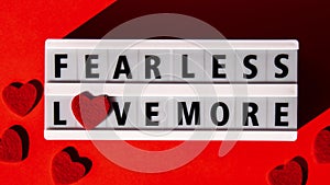 4k zoom in out Lightbox with text FEAR LESS LOVE MORE. Motivational Words Quotes Concept with red hearts. Colorful red