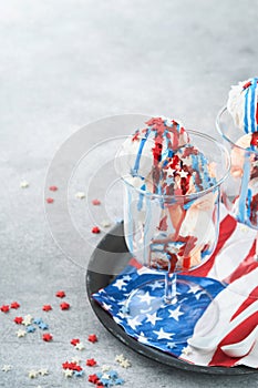 4th of July American Independence Day food or drink. Crazy milkshake with strawberry and vanilla ice cream white, blue, red colors