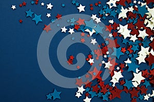 4th of July American Independence Day stars decorations on blue background. Flat lay, top view.