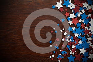 4th of July American Independence Day stars decorations on wooden background. Flat lay, top view.