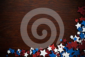 4th of July American Independence Day stars decorations on wooden background. Flat lay, top view.