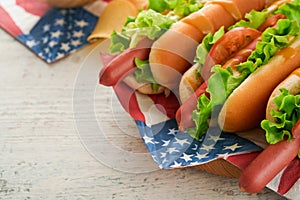 4th of July American Independence Day traditional picnic food. Hot dog with potato chips and cocktail, American flags and symbols