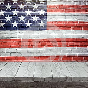 4th of july background with wooden table over USA flag painted on brick wall