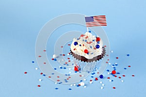 4th of July cupcake with flag, sprinkles