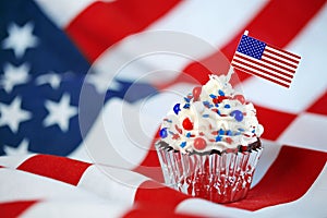 4th of July cupcake with flag, sprinkles