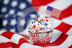 4th of July cupcake with flag, sprinkles