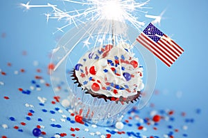 4th of July cupcake with flag, sprinkles, sparkler