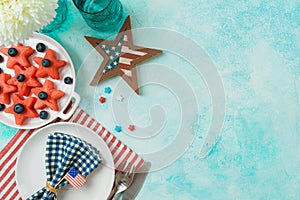 4th of July festive table setting  with summer fruit salad, plate and decorations. Happy Independence Day party background. Top