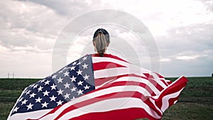 4th of July, Independence day, celebration. Patriot woman with american USA waving flag. Rear view, US banner, memorial