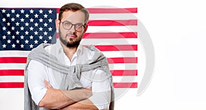 4th of July. Smiling young man on United States flag background.
