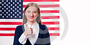 4th of July. Smiling young woman on United States flag background.