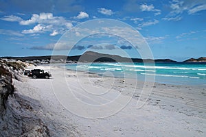 4WD cars parked on white sandy beach at Lucky Bay, Western Australia