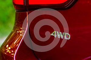 4WD emblem on modern SUV car detail close up view.