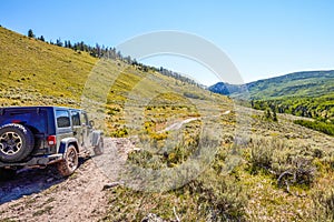 4WD vehicle driving off road through mountains