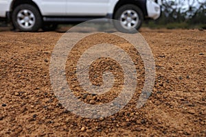 4WD vehicle driving on a very corrugate dirt road in Australia outback