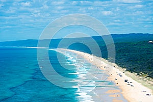 4wd vehicles at Rainbow Beach with coloured sand dunes, QLD, Australia