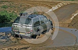 4x4 car crossing a puddle