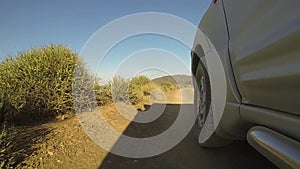 4x4 car driving on a dirt road