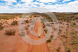 4x4 car driving down a dusty red road