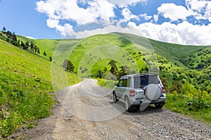 4x4 car driving on M-20 winding gravel road towards Tskhratskaro Pass, Georgia