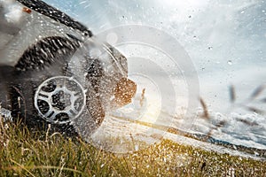 4x4 car wheel and water splashes