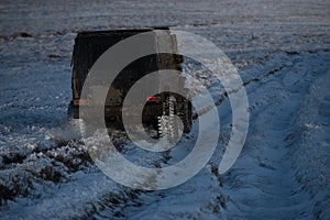 4x4 Off-road suv car. Wheel close up in a countryside landscape with a muddy road. Off-road vehicle goes on the mountain