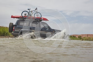 4X4 off road vehicle crossing river, Extreme off-road tour in the forest