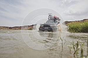 4X4 off road vehicle crossing river, Extreme off-road tour in the forest