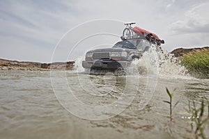 4X4 off road vehicle crossing river, Extreme off-road tour in the forest