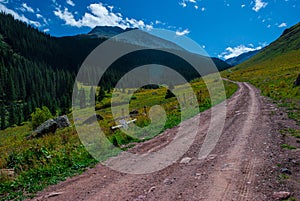 4x4 Off Road Vehicle dirt road heading up the Mountains