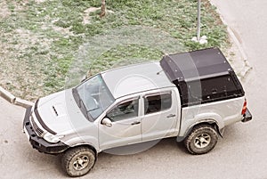 4x4 Pickup truck with offroad wheels. Dirty SUV after off-road driving. View from above. Powerful tire tread on car