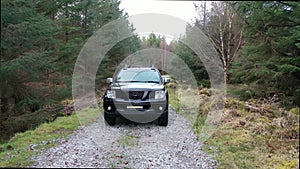 4x4 pickup vehicles driving through forest - all brands removed