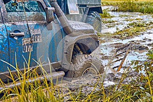 4x4 SUV stuck in a swamp during extreme competitions is pulled out using a winch