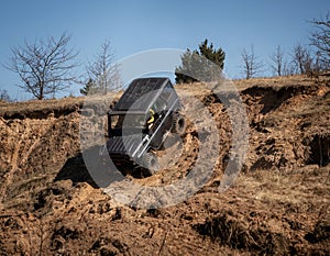 4x4 suv truck driving downhill on edge of hill