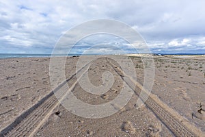 4x4 tire tracks on a sandy beach