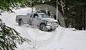 4x4 truck drifting on winter snow road in forest