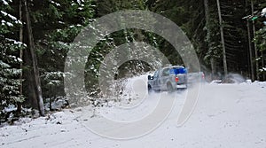 4x4 truck drifting on winter snow road in forest