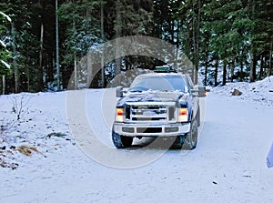 4x4 truck drifting on winter snow road in forest