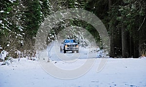 4x4 truck drifting on winter snow road in forest