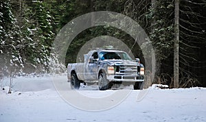 4x4 truck drifting on winter snow road in forest