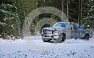 4x4 truck drifting on winter snow road in forest